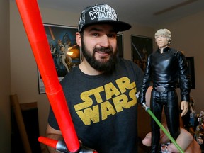 Windsor resident and self-described Star Wars mega-fan Scott Despins with some of his Lucasfilm paraphernalia.