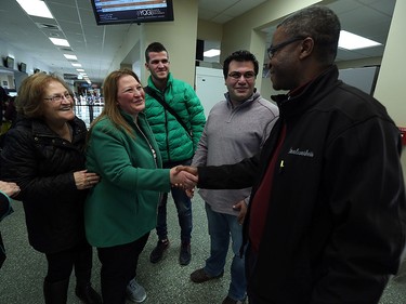 Sohier Ashkar is introduced to Gilbert Iyamuremye (right) by her brother Fadi Ashkar (centre) after arriving in Windsor on Friday, Dec. 11, 2015. The Syrian family arrived from Lebanon after a stop over in Toronto.