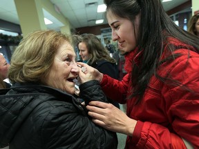 Rawan Farah is greeted by her grandmother Salam Ashkar (left) after arriving in Windsor on Friday, Dec. 11, 2015. The Syrian family arrived from Lebanon after a stop over in Toronto.