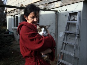 Manning Road resident Kim Rudnikoff with one of her pet cats, Nushka, Thursday Dec. 3, 2015. Rudnikoff's neighbours have been frustrated by their constant complaints to Town of Tecumseh officials about dozens of cats which live at the single-family home and detached garage.