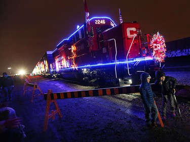 Pierce (left) and Lieneke Laflamme-Perrin pose for a quick picture in front of the locomotive at the CP Holiday Train at the CP rail yard in Windsor on Wednesday, Dec. 2, 2015.