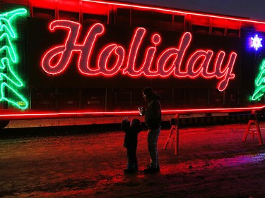 Leyland Vallance and his dad Ryan Vallance stop to snap a picture at the CP Holiday Train at the CP rail yard in Windsor on Wednesday, Dec. 2, 2015.