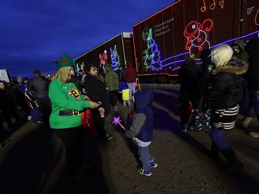Annette Campbell hands out candy canes at the CP Holiday Train at the CP rail yard in Windsor on Wednesday, Dec. 2, 2015.