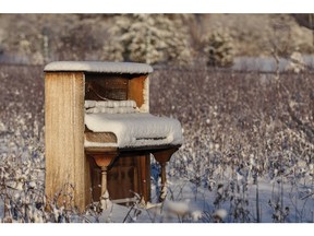 Upright piano abandoned in a snowy winter field. Photo by fotolia.com