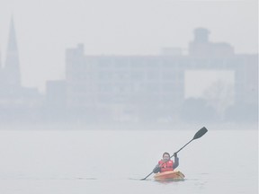 Paul Rumiel takes advantage of the unseasonably warm weather Saturday, Dec., 12, 2015, to go kayaking in the Detroit River.