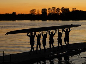 LaSalle, Oct. 14, 2015:  Members of the LaSalle Rowing Club carry in the boats after an evening on the Detroit River.