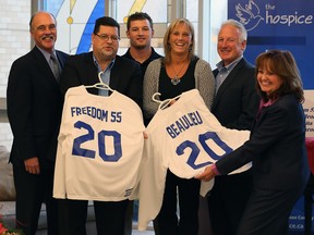 Hospice executive director Carol Derbyshire, right, presents two hockey jerseys to sponsor Freedom 55 and the Beaulieu family during a Hockey for Hospice kickoff celebration at Hospice Wellness Centre on Monday Dec. 7, 2015. Al Broadbent, left, and Paul Piertraszko, both of Freedom 55, and Corey Beaulieu, centre, joined by his parents Janet and Tim Beaulieu, centre right, were honoured during the luncheon.