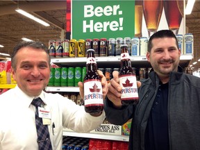 Superstore manager John Carvalho, left, and Molson Coors sales rep Stefan Kovacevic with congratulatory Superstore Molson Canadian beer presented during opening at 9 AM Tuesday morning Dec. 15, 2015.