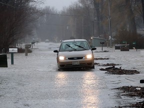 Flooding caused by high winds and waves from Lake Erie is seen on Lakeshore Drive near Fox Run Road in Leamington, Ont.  Fierce, Lake Erie waves hammered the Leamington shore on Dec. 28, 2015.