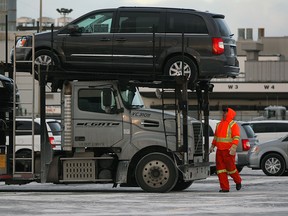 Windsor-built 2015 Dodge Grand Caravans and Chrysler Town and Country minivans leave Windsor Assembly Plant after rolling off the line Monday, Jan. 5, 2015.