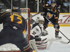 Windsor goalie Mario Culina, centre, makes a save on Kevin Labanc, left, while Justin Scott looks for a rebound Saturday at the Molson Centre in Barrie. (Mark Wanzel Photography)