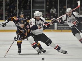 Windsor's Hayden McCool, right, is checked by Barrie's Rasums Anderson Saturday in Barrie.  (Mark Wanzel Photography)