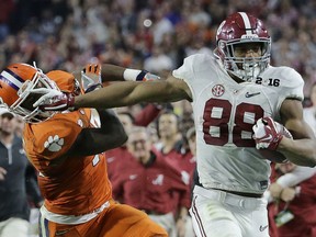 Alabama's O.J. Howard tries to get past Clemson's T.J. Green after a catch during the second half of the NCAA college football playoff championship game Monday, Jan. 11, 2016, in Glendale, Ariz. (AP Photo/David J. Phillip)