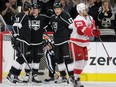 Los Angeles Kings center Anze Kopitar (11), of Slovenia,  and left wing Milan Lucic (17) congratulate center Tyler Toffoli, second from left, for scoring as Detroit Red Wings defenseman Mike Green (25) skates by during the first period of an NHL hockey game in Los Angeles, Monday, Jan. 11, 2016. (AP Photo/Alex Gallardo)