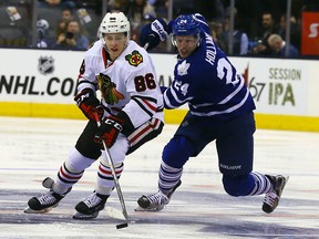 Peter Holland of the Toronto Maple Leafs chases Teuvo Teravainen of the Chicago Blackhawks during NHL action at the Air Canada Centre in Toronto on Friday January 15, 2016. Dave Abel/Toronto Sun/Postmedia Network