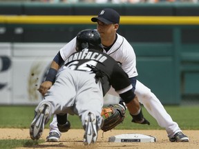 Detroit Tigers shortstop Jose Iglesias, top, waits for the throw to tag out Chicago White Sox's Emilio Bonifacio on a steal-attempt during the seventh inning of a baseball game, Sunday, June 28, 2015, in Detroit. (AP Photo/Carlos Osorio)