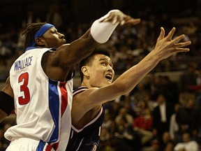 Ben Wallace, at left, is seen in action during his playing days with the Detroit Pistons guarding Houston's Yao Ming. Wallace rejoined the team on Friday.