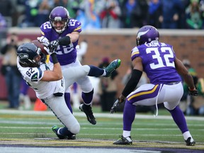 Harrison Smith #22 of the Minnesota Vikings tackles Luke Willson #82 of the Seattle Seahawks in the first quarter on December 6, 2015 at TCF Bank Stadium in Minneapolis, Minnesota. (Photo by Adam Bettcher/Getty Images)