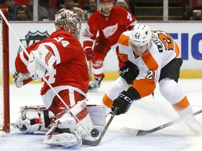 Detroit Red Wings goalie Petr Mrazek (34) stops a Philadelphia Flyers center Scott Laughton (21) shot in the third period of an NHL hockey game, Sunday, Jan. 17, 2016 in Detroit. (AP Photo/Paul Sancya)