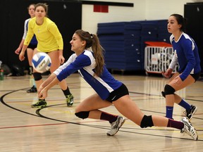 St. Anne Saints Hannah Drkulec, centre, sets a hard serve for teammates Madison Tracey and Molly Heath, right, in game against Tecumseh Vista in senior girls high school volleyball  Jan. 19, 2016.