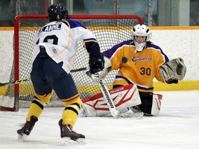 The St. Anne Saints Stephane Crevier fires a shot at the Kingsville Cavaliers John Prout at Tecumseh Arena on Monday, January 18, 2016.                 (TYLER BROWNBRIDGE/The Windsor Star)