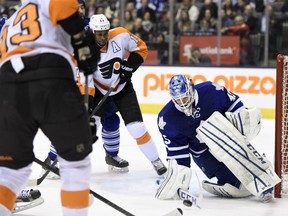 Toronto Maple Leafs goalie Jonathan Bernier makes a save as Philadelphia Flyers' Wayne Simmonds (17) and Jakub Voracek (93) look for a rebound during first period NHL action in Toronto on Thursday February 26, 2015. THE CANADIAN PRESS/Frank Gunn