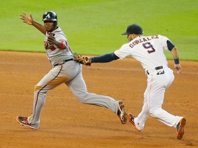 Justin Upton #8 of the Atlanta Braves is tagged out in Atlanta Braves rundown by Marwin Gonzalez #9 of the Houston Astros during the fifth inning of their game at Minute Maid Park on June 26, 2014 in Houston, Texas.  (Photo by Scott Halleran/Getty Images)