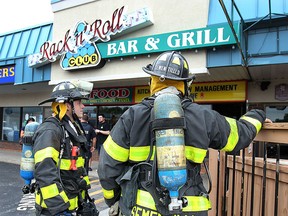 Windsor firefighters are shown at the scene of a fire at the Rack n' Roll restaurant in Forest Glade on Monday, June 8, 2015. (DAN JANISSE/The Windsor Star)