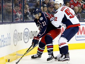 Columbus Blue Jackets' Kerby Rychel, left, tries to control the puck as Washington Capitals' Evgeny Kuznetsov, of Russia, defends during the second period of an NHL hockey game, Tuesday, Jan. 19, 2016, in Columbus, Ohio. (AP Photo/Jay LaPrete)
