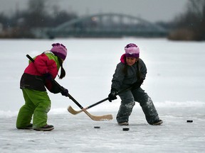 Olivia Gut, 7, and her twin sister Avery Gut, 7, enjoy a family outing on River Canard January 20, 2016. The twins were perfecting their shots with sister Samantha, 9, father Gavin Gut and pet labrador, Gideon.