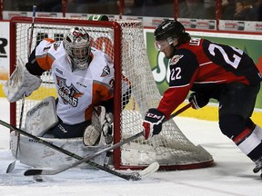 Windsor Spitfires Brendan Lemieux, right, tries a wrap-around shot against Flint Firebirds goaltender Brent Moran  in OHL hockey action in this January 2016 file photo.