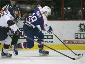 Windsor's Christian Fischer is chased by Saginaw's Markus Niemelainen, left, during the second period of OHL action between the Windsor Spitfires and the Saginaw Spirit at the WFCU Centre, Sunday, Jan. 3, 2015.  Windsor defeated Saginaw 7-1.   (DAX MELMER/The Windsor Star)