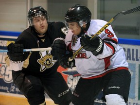 Vipers Blake Jones slows down Lambton Shores Franco Sproviero, right, in Jr. B action from Vollmer Centre January 6, 2016.