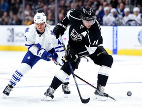 Anze Kopitar #11 of the Los Angeles Kings loses the puck as he is checked by Michael Grabner #40 of the Toronto Maple Leafs during the second period at Staples Center on January 7, 2016 in Los Angeles, California.  (Photo by Harry How/Getty Images)