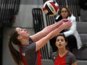 With her back to the net, Brennan Cardinals saves the ball in front of teammate Haley Straub against Essex Red Raiders in senior girls volleyball at Brennan gym January 7, 2016.  (NICK BRANCACCIO/Windsor Star)