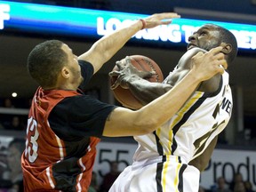 Windsor Express player Jahmal McQueen puts pressure on London Lightning player Mustafaa Jones as he looks to score during their NBL Canada basketball game at Budweiser Gardens in London, Ont. on Tuesday December 29, 2015. Craig Glover/The London Free Press/Postmedia Network