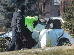 Amherstburg police officers investigate the scene of a single vehicle roll over on Monday, Jan. 18, 2016, in the 2100 block of Front Road. The male driver suffered life threatening injuries.