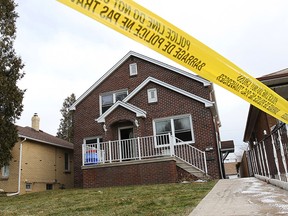 Yellow police tape surrounds a duplex home at 1564-66 Benjamin Ave., Sunday, Dec. 14, 2014