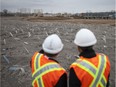 Minister of Infrastructure and Communities, Amarjeet Sohi, and Michael Cautillo, CEO of the Windsor-Detroit Bridge Authority, left, uses tour the site for the future customs plaza to the Gordie Howe International Bridge, Thursday, Dec. 17, 2015.  (DAX MELMER/The Windsor Star)