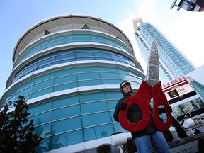 Protester John Jones holds a giant pair of scissors during a rally outside of Caesars Windsor on Tuesday, Jan. 19, 2016. Local politicians were hold pre budget meetings inside.