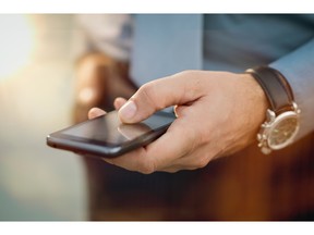 Businessman using cellphone. Photo by fotolia.com.