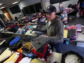 John Kerr sorts donated clothes at the Rose City Islamic Centre in Windsor on Friday, Jan. 29, 2016. Clothes are being collected for the recently arrived Syrian families.