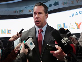 Reid Bigland, CEO of FCA Canada, speaks to media in front of the newly unveiled Chrysler Pacifica minivan on Monday at the Detroit auto show.