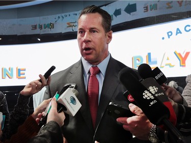 Reid Bigland, CEO of FCA Canada, speaks to media in front of the newly unveiled Chrysler Pacifica minivan on Monday at the Detroit auto show.