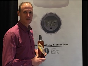 Don Livermore, the master blender at Hiram Walkers distillery, displays a bottle of the award-winning Lot No. 40 during the Canadian Whisky Awards in Victoria, B.C.