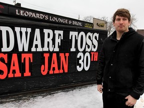 Sam Katzman of Katzman Enterprises stands by a sign at Leopard's Lounge advertising the strip club's dwarf-tossing event on Jan. 30, 2016. It's been four years since Leopard's last hosted such an event. Katzman expects attendance to be more than 500.