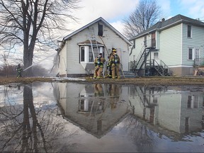 Windsor firefighters are shown at the scene of a house fire in the 800 block of Wellington Avenue on Wednesday, Jan. 27, 2016. The boarded up home was destroyed.