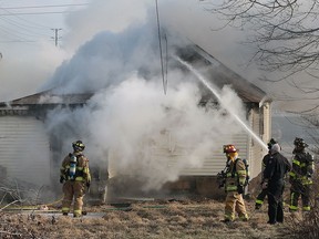 Windsor firefighters are shown at the scene of a house fire in the 800 block of Wellington Avenue on Wednesday, Jan. 27, 2016. The boarded up home was destroyed.