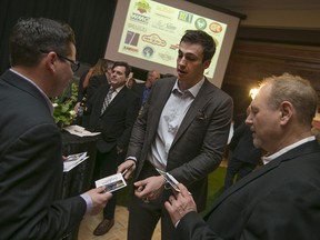 NFL tight-end, Luke Willson, signs autographs for attendees, including DWBIA president, Larry Horwitz, right, of the Gridiron Gala at the Caboto Club, Friday, Jan. 29, 2016.  The event is benefitting the Windsor Stadium restoration project.