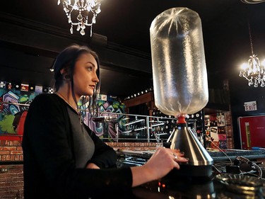 Staff member Emily Perry, 21, operates a Volcano brand vaporizer at Higher Limits in downtown Windsor.